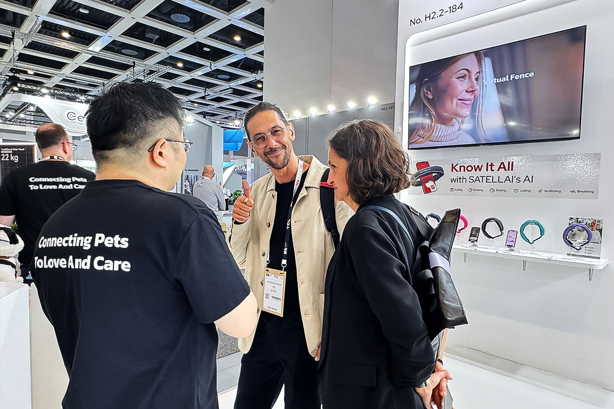 Visitors discussing PETVORA AI pet collar features at IFA Berlin